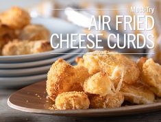 air fried cheese curls on a plate with plates in the background and text overlay