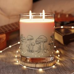 a lit candle sitting on top of a table next to a guitar and other items