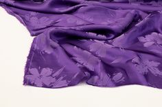 This jacquard has a satin finish and a fluid drape. Elegant Silk Fabric With Satin Finish, Elegant Purple Silk Fabric, Elegant Silk Fabric For Spring, Satin Finish, Satin, Purple