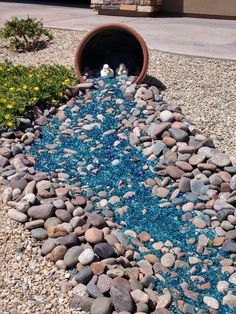 a garden with rocks and gravel in the middle