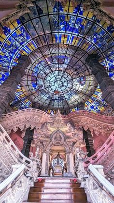 an ornate building with stained glass windows and stairs