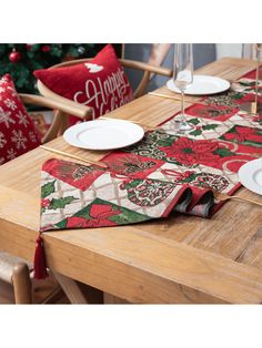 the table is set for christmas dinner with plates and napkins on top of it