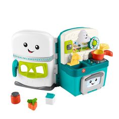 a toy kitchen playset with lots of food in it's storage compartment, including an ice cream dispenser