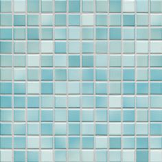 a close up view of a blue tile wall with white and light blue squares on it