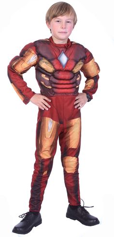 a young boy in a red and gold costume standing with his hands on his hips