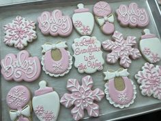 decorated cookies in pink and white on a tray