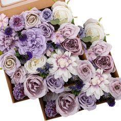 a box filled with lots of purple and white flowers