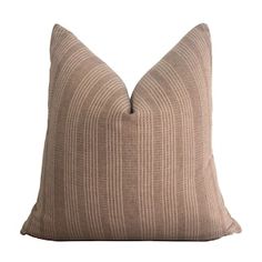 a beige pillow with a brown stripe pattern on the front and back, sitting on a white background