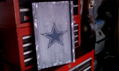 a sign with a star on it hanging from the side of a red toolbox