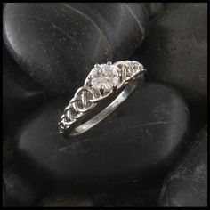 a diamond ring sitting on top of some rocks