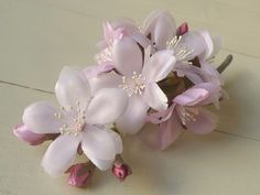 a bouquet of pink flowers sitting on top of a table