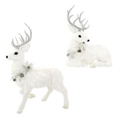 two white deer figurines sitting next to each other