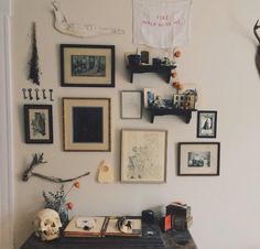 there are many pictures on the wall with skulls and other things around them, including a skull