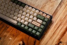 a computer keyboard sitting on top of a wooden table