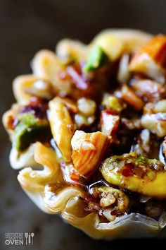 a bowl filled with pasta and vegetables on top of a table