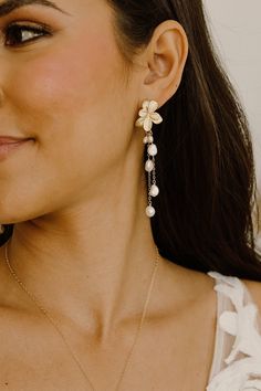 Our Gigi Pearl Earrings are the perfect combination of boho and bridal styles! These stunning earrings feature multiple delicate pearl drops that dangle elegantly from flower posts, making them the perfect addition to any wedding or special occasion outfit. These Earrings boast a dainty and elegant design that is sure to turn heads. The wire-wrapped pearls add a touch of sophistication and glamour to these already stunning earrings. Whether you're the bride-to-be or a guest, these earrings are sure to elevate any outfit. With their timeless pearl drop design, the Gigi Pearl Earrings make for a wonderful gift for a loved one or as a keepsake for yourself. They're perfect for anyone who appreciates the beauty of delicate and intricate jewelry. Find the matching necklace here: https://etsy.me Wedding Guest Earrings, Pearl Dangle Earrings Wedding, Statement Wedding Earrings, Boho Bridal Earrings, Pearl Drop Earrings Bridal, Earrings Pearl Drop, Bridal Styles, Occasion Outfit