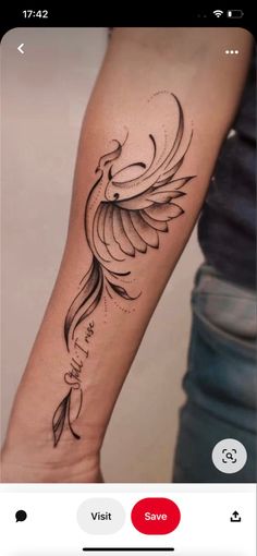 a woman's arm with a bird tattoo on it