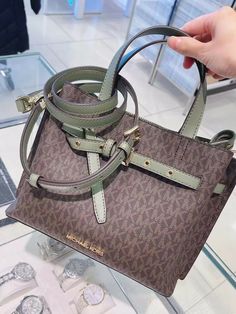 NWT Michael Kors Emilia Large Crossbody Handbag Satchel Signature/Sage $448. DESCRIPTION: Satchel Logo-print canvas 74% coated canvas/19% polyester/7% polyurethane Gold-tone hardware 12.5”W X 9.5”H X 6”D Handle drop: 5” Adjustable strap: 18"-22" Exterior details: detachable crossbody strap, front and back snap pockets Interior details: back zip pocket, front slip pocket Lining: 100% polyester Zip fastening. Satchel Bags Michael Kors, Snap Bag, Handbag Satchel, Exterior Details, Gold Bag, Coat Patterns, 6 D, Brown Fashion, Zipper Bags