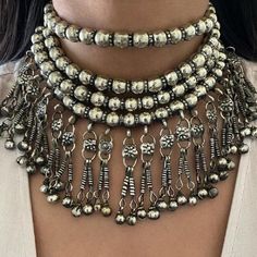 * The silver beads work has made this astonishing four-layer choker an authentic traditional craft. This iconic necklace is visibly quite sizable, but it is light in weight and is quite low maintenance. * The dazzling plain silver necklace has all the classical vibes as it is inspired by the ethnic jewelry design. The tassels at the bottom of the necklace are perfectly going with the design of the necklace. * You can pair this amazing antique necklace with any of your attire, traditional or mode Classical Vibes, Handmade Antique Jewelry, Handmade Choker Necklace, Boho Cuff Bracelet, Hand Cuff Bracelet, Kuchi Jewelry, Moroccan Jewelry, Handmade Chokers, Afghan Jewelry