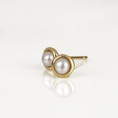 These are classy small Pearl gold earrings, handmade of yellow 14k solid gold with white freshwater pearls. They have a shiny finish. These pearl stud earrings are a touch of softness, earrings you will enjoy wearing all day long for many years. They can be a perfect match for a pearl necklace, or a gold necklace. Fine earrings, delicate and timeless, a wonderful treat for yourself or for someone you love. Pearl's diameter is about 3.7 mm = ~0.15 inch Earring's diameter is 5.3 mm = ~0.2 inch 14k Timeless 14k Gold Pearl Earrings For Gift, Classic 14k Yellow Gold Pearl Earrings, Classic 14k Gold Matching Pearl Earrings, Classic 14k White Gold Pearl Earrings, Classic 14k Gold Pearl Earrings For Pierced Ears, Classic Pearl Earrings In Yellow Gold, Classic Everyday Akoya Pearl Earrings, Classic Yellow Gold Earrings With Pearl Charm, Classic Yellow Gold Pearl Earrings As Gift