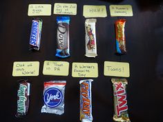 several different types of candy on display with notes attached to the wrappers and labels