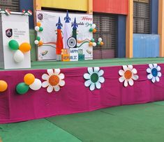 the table is decorated with flowers and balloons