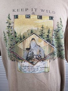 "Here's a shirt from the 90's with a powerful message. At the top it reads 'Keep it wild & free' and the quote states: 'Nothing lives long, But the earth and the mountains, What remains in the fire, Becomes the final song.' No significant age wear. Vintage fade. Size is men's L. Measurements (taken lying flat): Shoulder (seam to seam) - 20\" Chest (armpit to armpit) - 21 1/2\" Sleeve length (shoulder seam to cuff) - 8 5/8\" Overall length - 31 3/8\" Present day, there is no more intimate way Free-spirited Cotton T-shirt With Graphic Print, Free-spirited Graphic Print Crew Neck Top, Free-spirited Crew Neck Top With Graphic Print, Free-spirited Cotton Graphic Print Tops, Free-spirited Cotton Tops With Graphic Print, Free-spirited Cotton Top With Graphic Print, Vintage Crew Neck Top With Embroidered Graphics, Vintage Summer Outdoor T-shirt, Graphic Print Cotton Top For Outdoor Activities