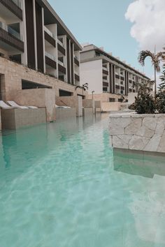 an empty swimming pool in front of a building