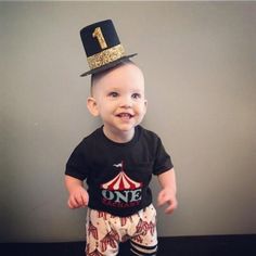 a little boy wearing a top hat and pants