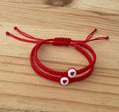 The Red String of Fate is a story of destiny that explains how people are meant to be together. They are linked by a red string attached to their hands until they find each other. It is also believed that the red string helps to channel positive energy for good luck and provide protection against evil. Bracelet Features: (1) 1mm Durable Nylon Cord (2) Bracelet is adjustable to fit most wrist sizes (3) Bracelet thickness (width) is 5mm (4) 7mm Acrylic Heart Bead Couple Bracelets String, Matching Bracelets String, Matching Beaded Bracelets For Couples, Red Braided Bracelets For Valentine's Day, Matching String Bracelets, Couple Bracelets Diy, Couple Beaded Bracelets, Cute Matching Bracelets, Nylon String Bracelet