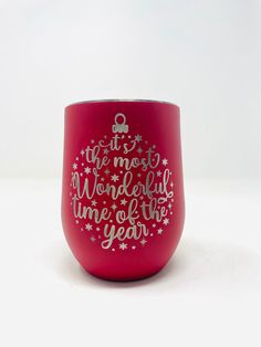 a red wine glass with the words it's most wonderful time of the year on it