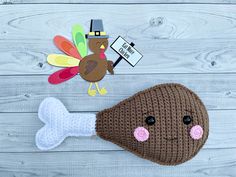 a crocheted turkey hat and bone with a thanksgiving turkey on the side next to it