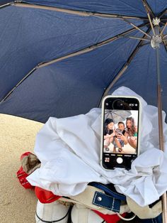 a cell phone sitting on top of an umbrella