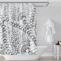 a white bath tub sitting next to a shower curtain