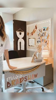 a woman standing next to a desk in an office