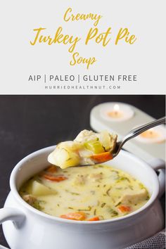 creamy turkey pot pie soup in a white bowl with a spoon