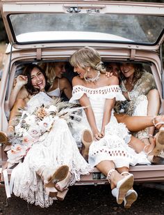 a group of women sitting in the back of a truck