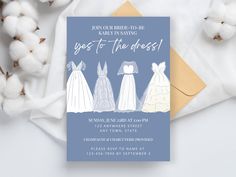 a card with three dresses on it next to cotton flowers and cotton balls in the background