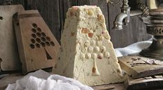 some kind of cake sitting on top of a wooden table next to other food items