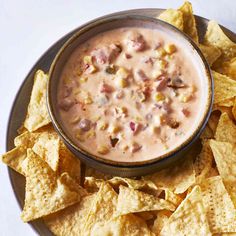 a plate with chips and a bowl of salsa