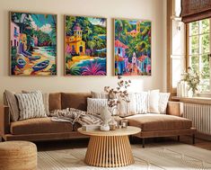 a living room with three paintings on the wall