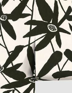 the black and white wallpaper is decorated with flowers, leaves and dots on it