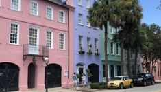 several colorful buildings line the street with palm trees