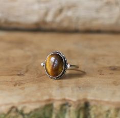 Sometimes you want to gaze down at your ring and see perfect balance and grace. That's what the Dainty Yellow Tigers Eye Delica Ring has to offer. High grade Yellow Tigers Eye with a simple, sterling silver design. Perfect little ring. Lovely, traditional, dainty ring of 10X12mm Yellow Tigers Eye cabochon set in .925 sterling silver oxidized and burnished bezel and wire. Simple, elegant and perfect. This lovely little ring is created using traditional silversmithing techniques in my Baltimore, M Adjustable Oval Spiritual Rings, Adjustable Sterling Silver Crystal Ring, Adjustable Sterling Silver Crystal Ring Classic Style, Classic Adjustable Sterling Silver Crystal Ring, Spiritual Oval Sterling Silver Rings, Nickel-free Oval Sterling Silver Crystal Ring, Adjustable Oval Sterling Silver Crystal Ring, Nickel-free Oval Crystal Ring In Sterling Silver, Adjustable Oval Crystal Ring In Sterling Silver