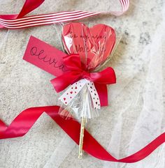 candy lollipops wrapped in red and white ribbon