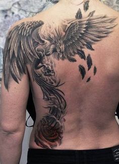 the back of a man's tattoo with an eagle and rose on his chest