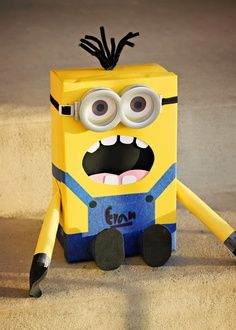 a yellow and blue minion sitting on the ground