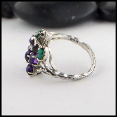 Custom Grape ring in Sterling Silver, set with oval Amethyst Cabochons, Marquise Emeralds, and diamonds. This ring is currently a size 7 1/4, and can be re-sized upon request. Original design © Tom CarterPlease call or email for more information800.488.6347 or service@walkermetalsmiths.com Sapphire Ring, Original Design, Original Designs, Grapes, Emerald, Sapphire, Amethyst, Diamonds, Size 7