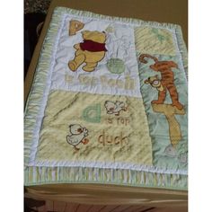 a winnie the pooh quilt on top of a bed