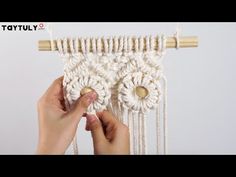 someone is holding up a white crochet piece